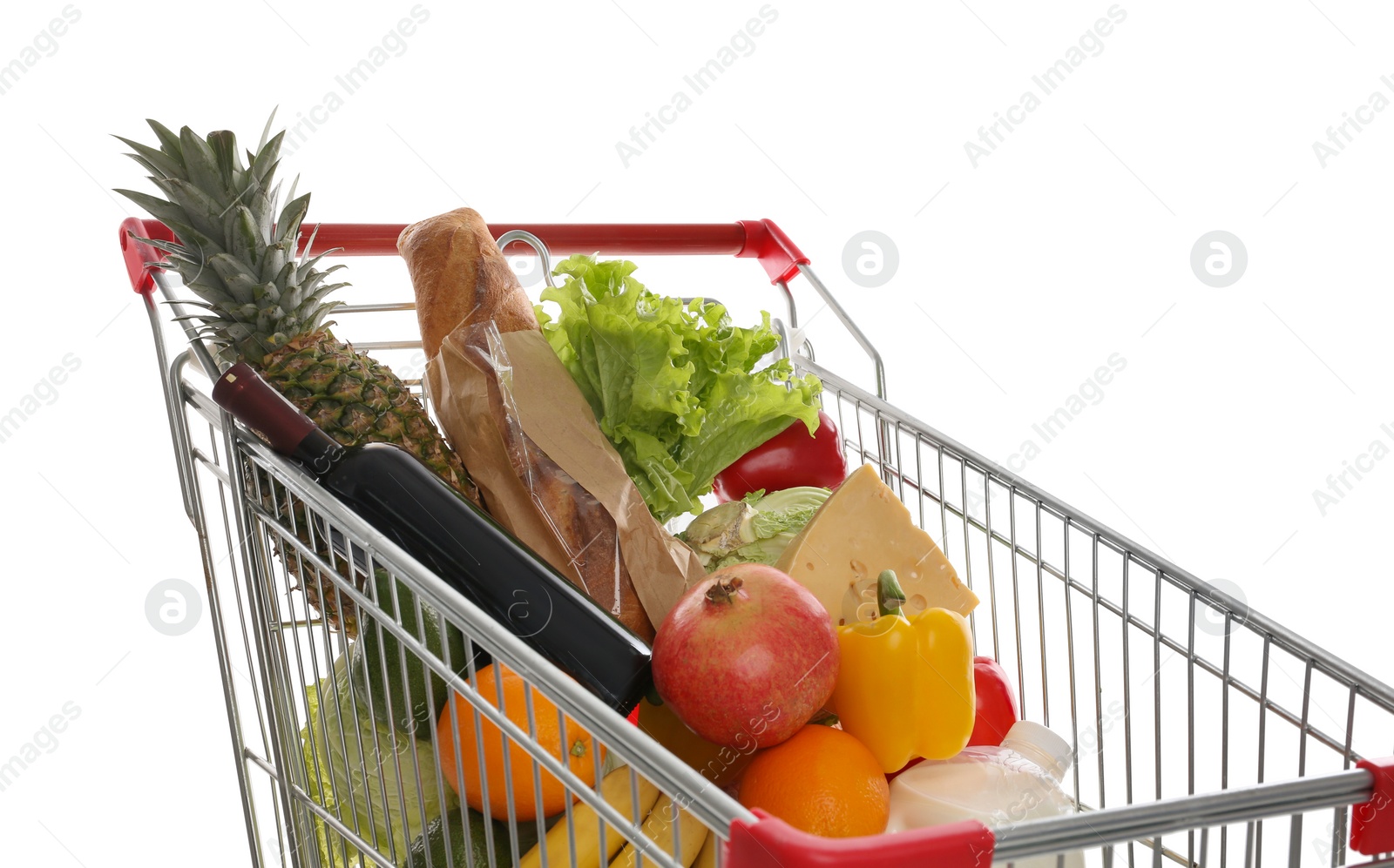 Photo of Shopping cart with groceries on white background