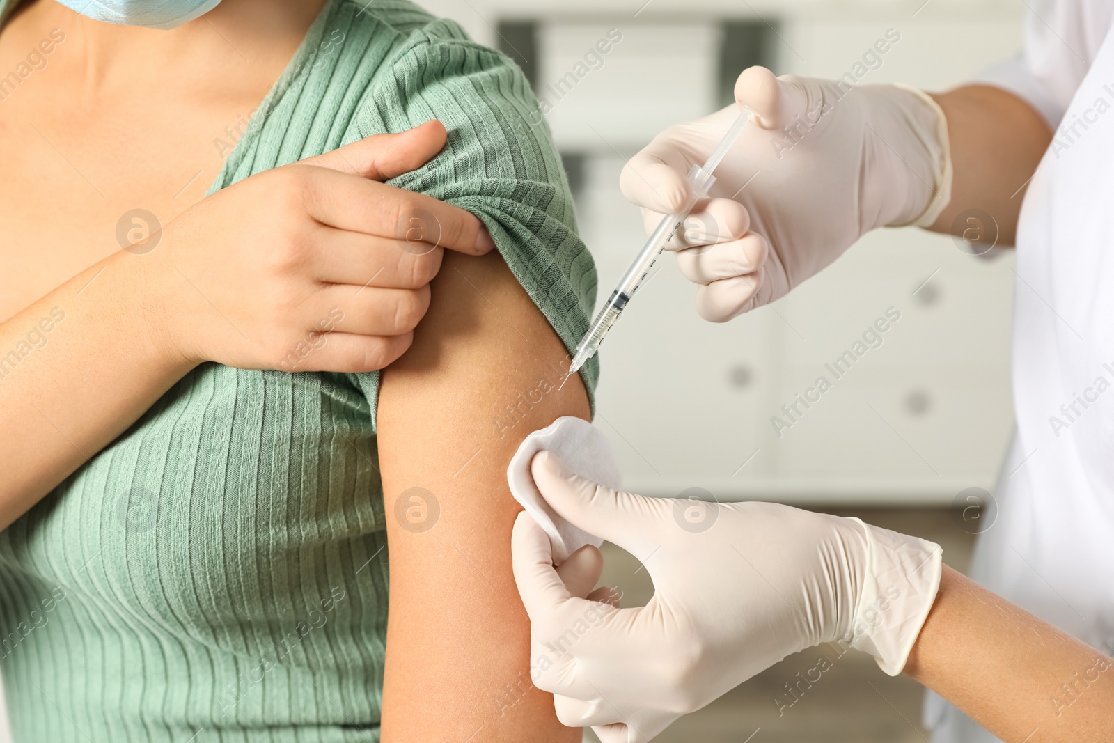 Photo of Doctor giving injection to patient in hospital, closeup. Vaccination day