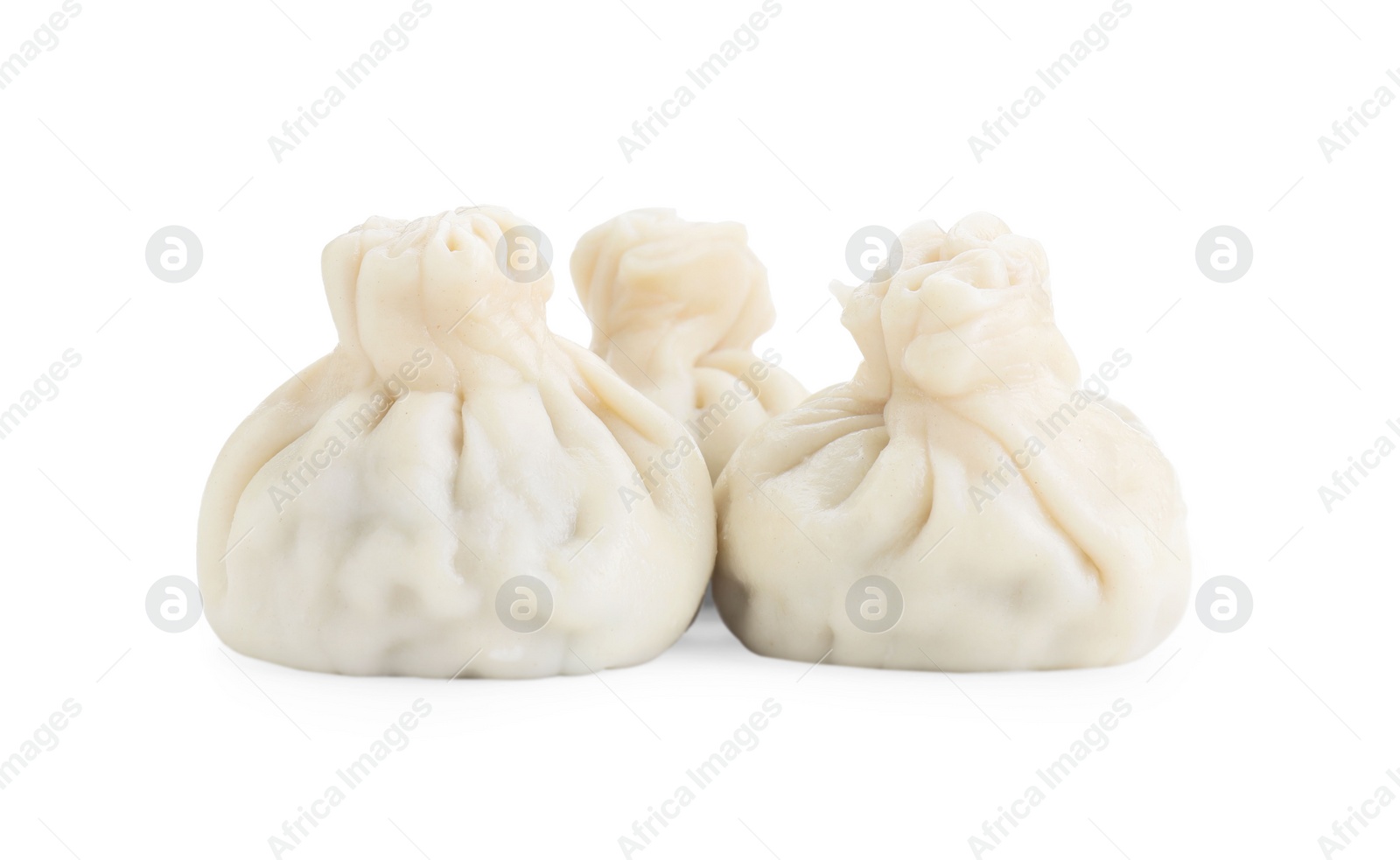 Photo of Three tasty khinkali (dumplings) isolated on white. Georgian cuisine