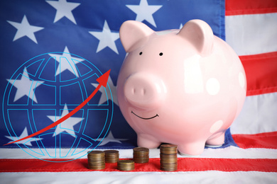 Image of Piggy bank with coins and growing arrow on USA national flag