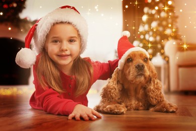 Cute little girl with English Cocker Spaniel in room decorated for Christmas. Magical festive atmosphere