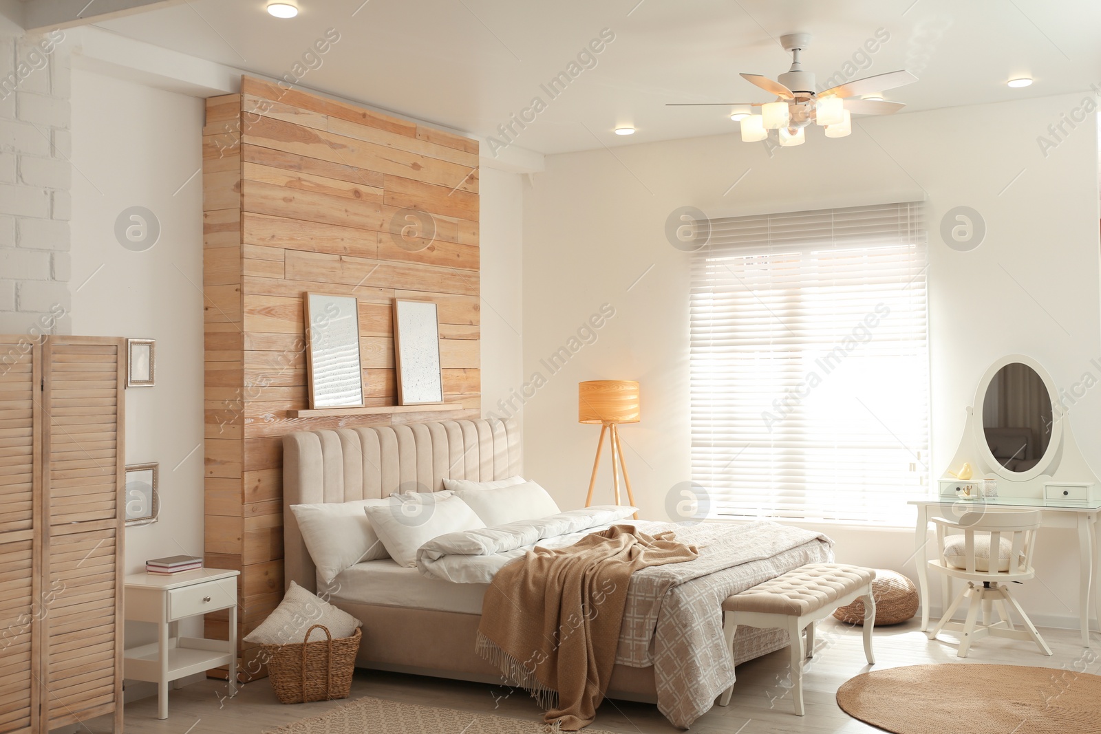 Photo of Stylish bedroom interior with modern ceiling fan and comfortable bench