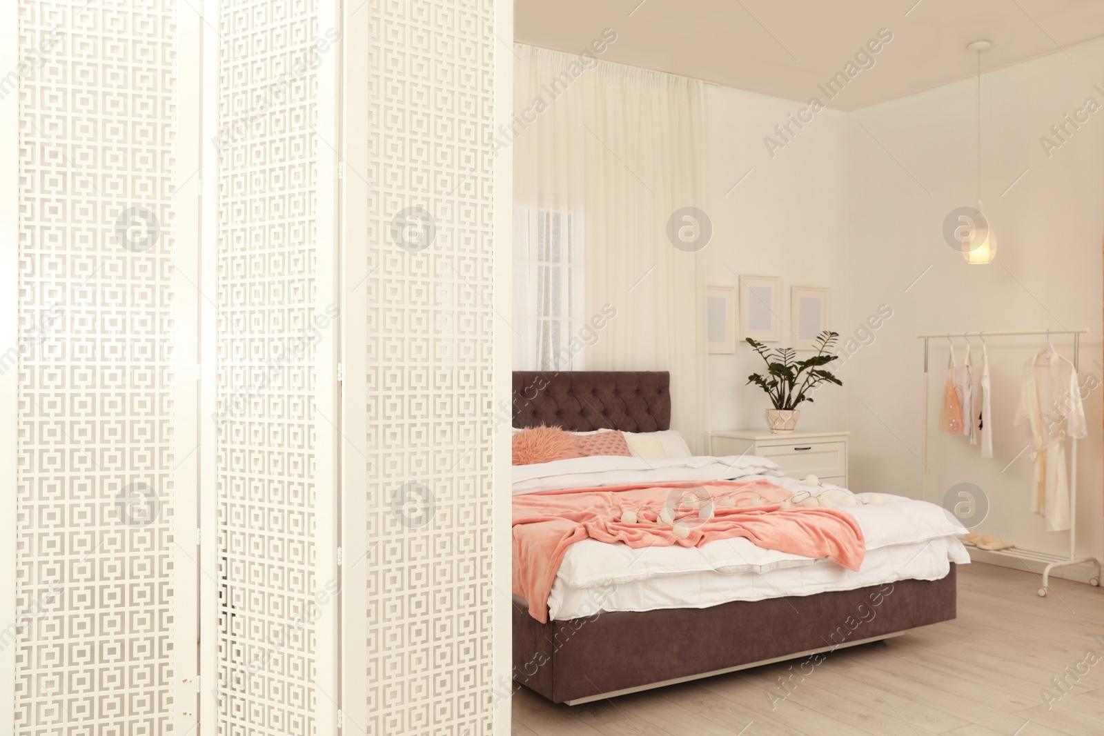 Photo of Modern folding screen in stylish bedroom interior