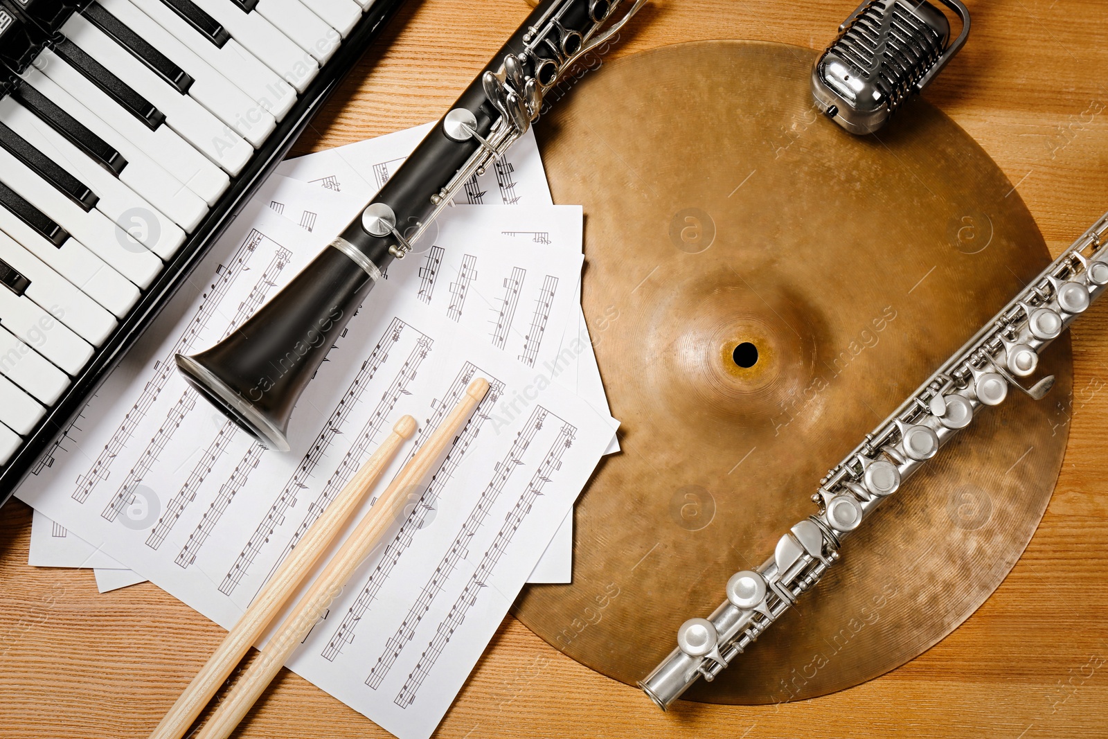 Photo of Set of different musical instruments on wooden background, flat lay