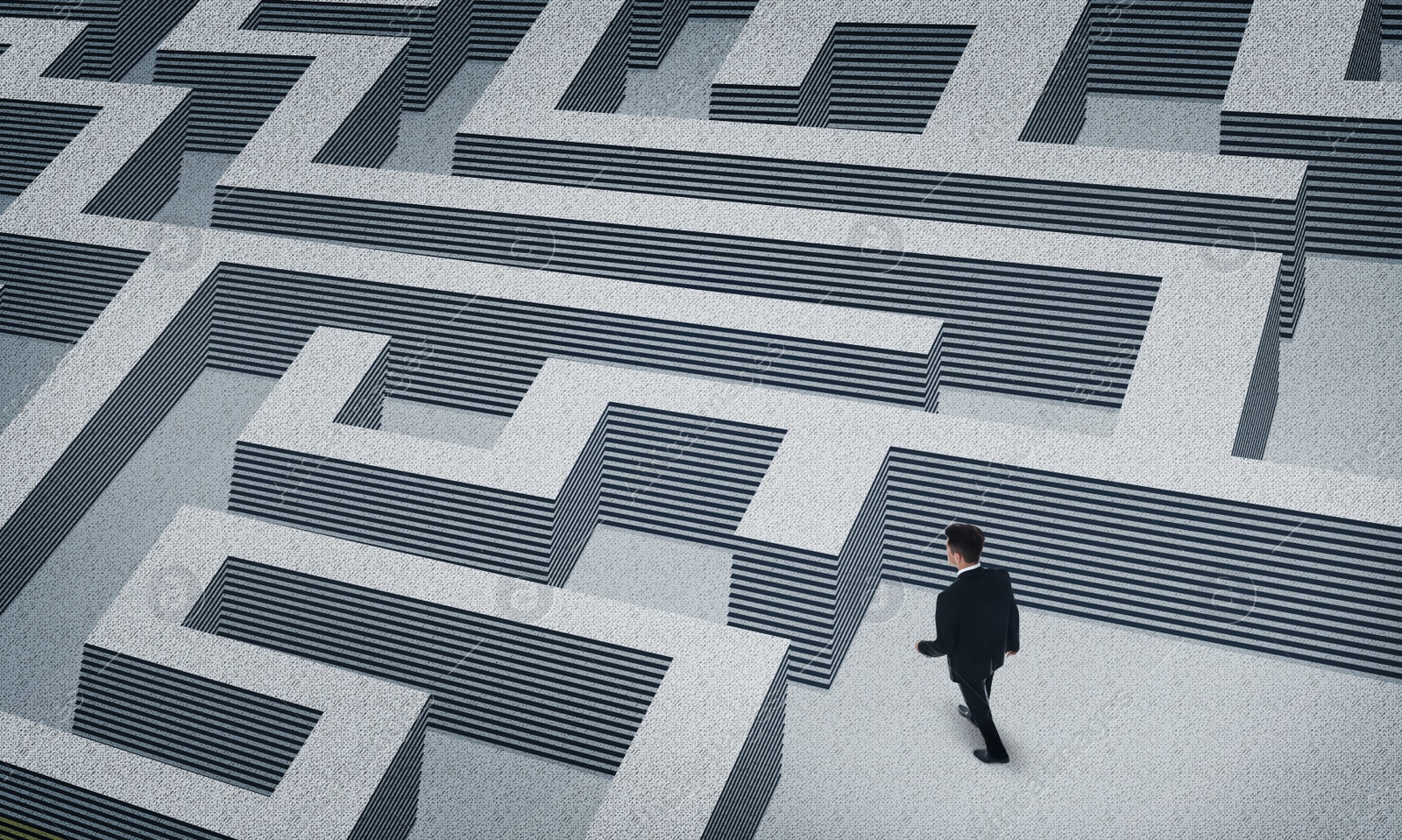 Image of Thoughtful businessman trying to find way out of maze