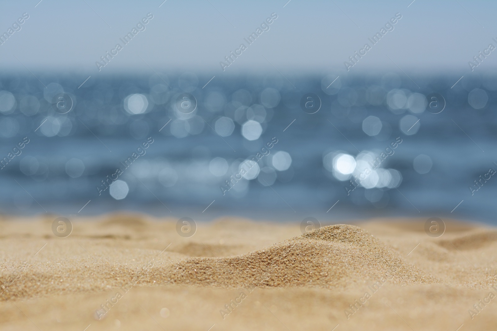 Photo of Sandy beach near sea on sunny day, closeup