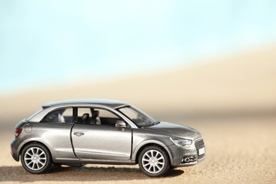 Photo of Miniature car model outdoors on sunny day. Space for text