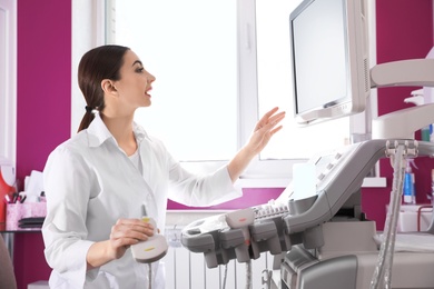 Sonographer using modern ultrasound machine in clinic