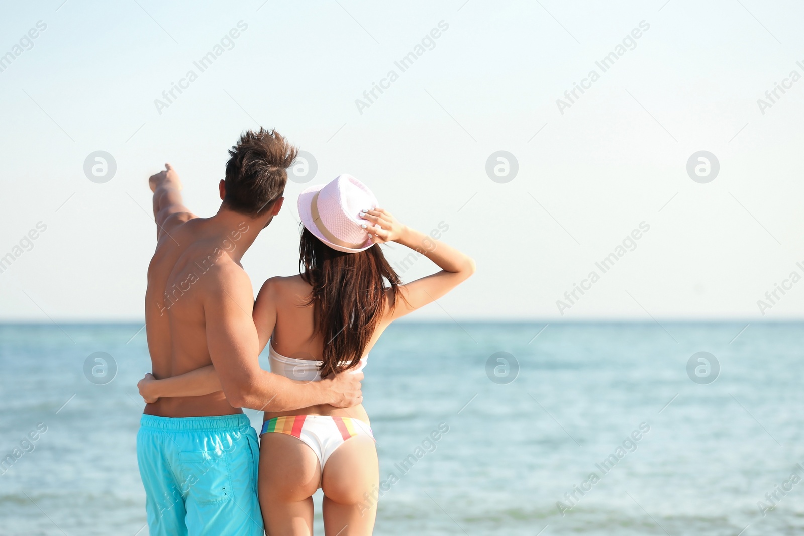 Photo of Happy young couple at beach on sunny day