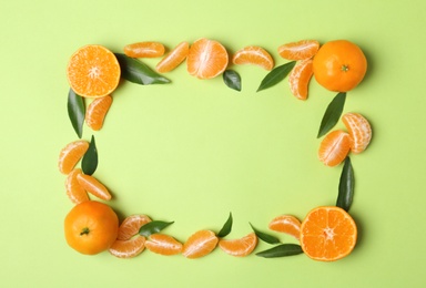 Composition with tangerines and leaves on color background, flat lay. Space for text