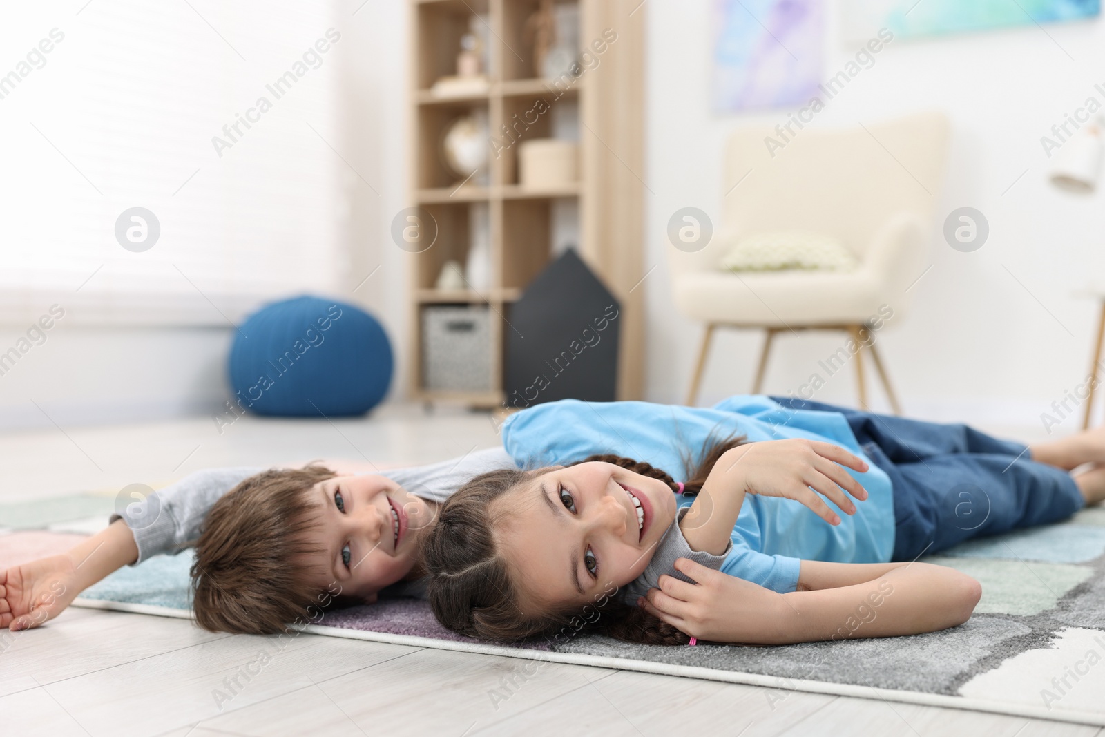 Photo of Happy brother and sister spending time together at home