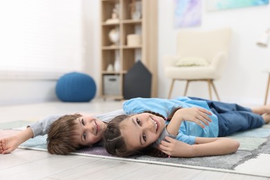 Photo of Happy brother and sister spending time together at home