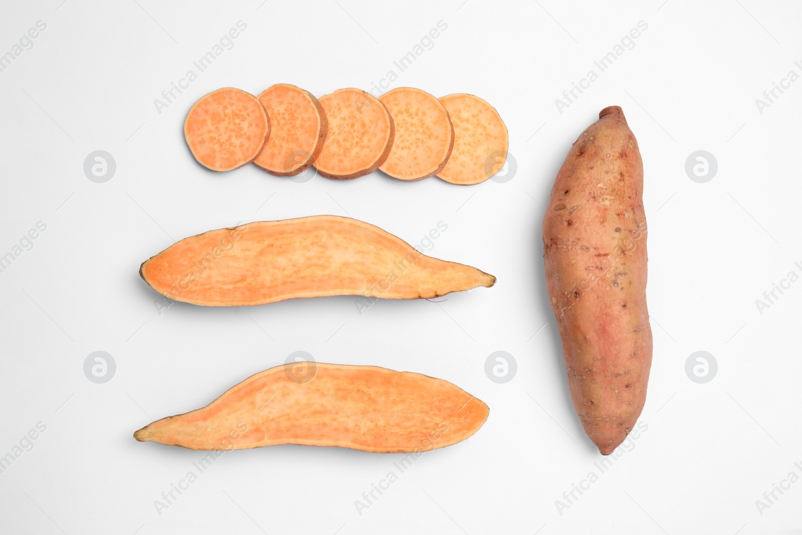 Photo of Cut and whole sweet potatoes on white background, top view