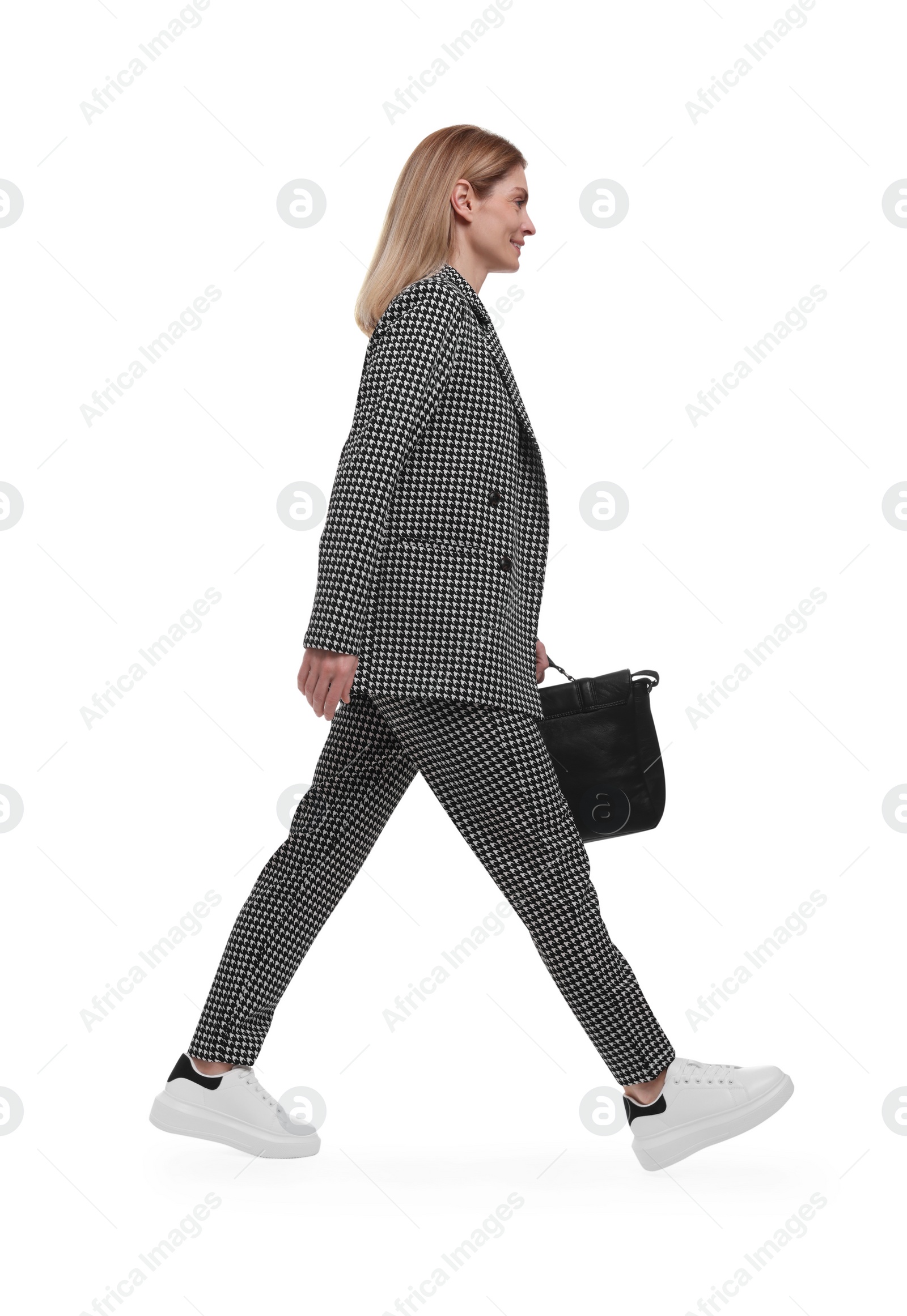 Photo of Beautiful happy businesswoman in suit with briefcase walking on white background