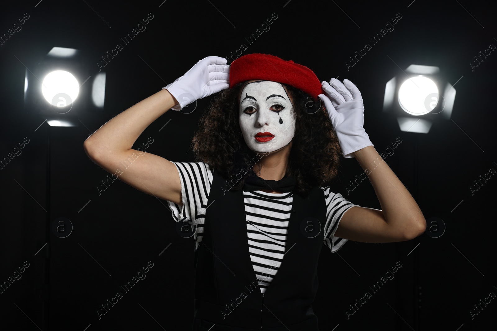 Photo of Young woman in mime costume performing on stage