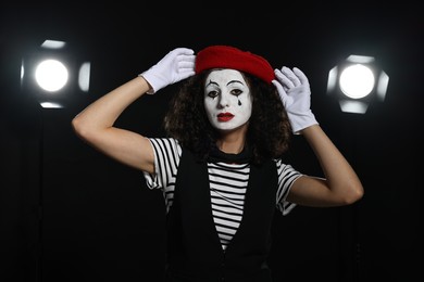 Photo of Young woman in mime costume performing on stage