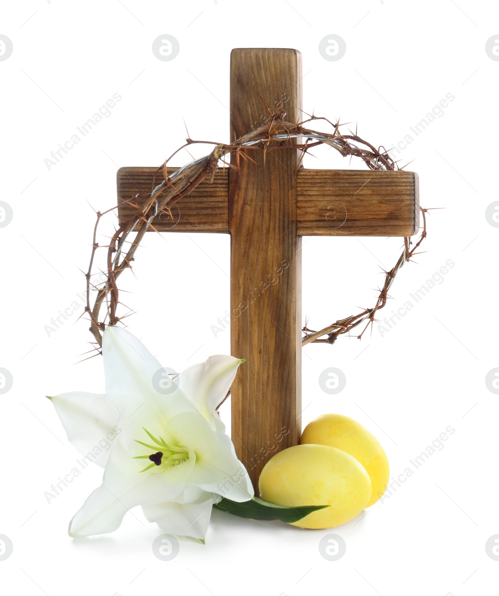 Photo of Wooden cross, crown of thorns, Easter eggs and blossom lily on white background