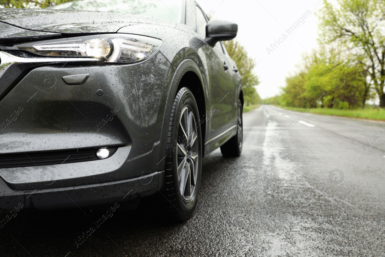 Photo of Car parked outdoors on rainy day, closeup