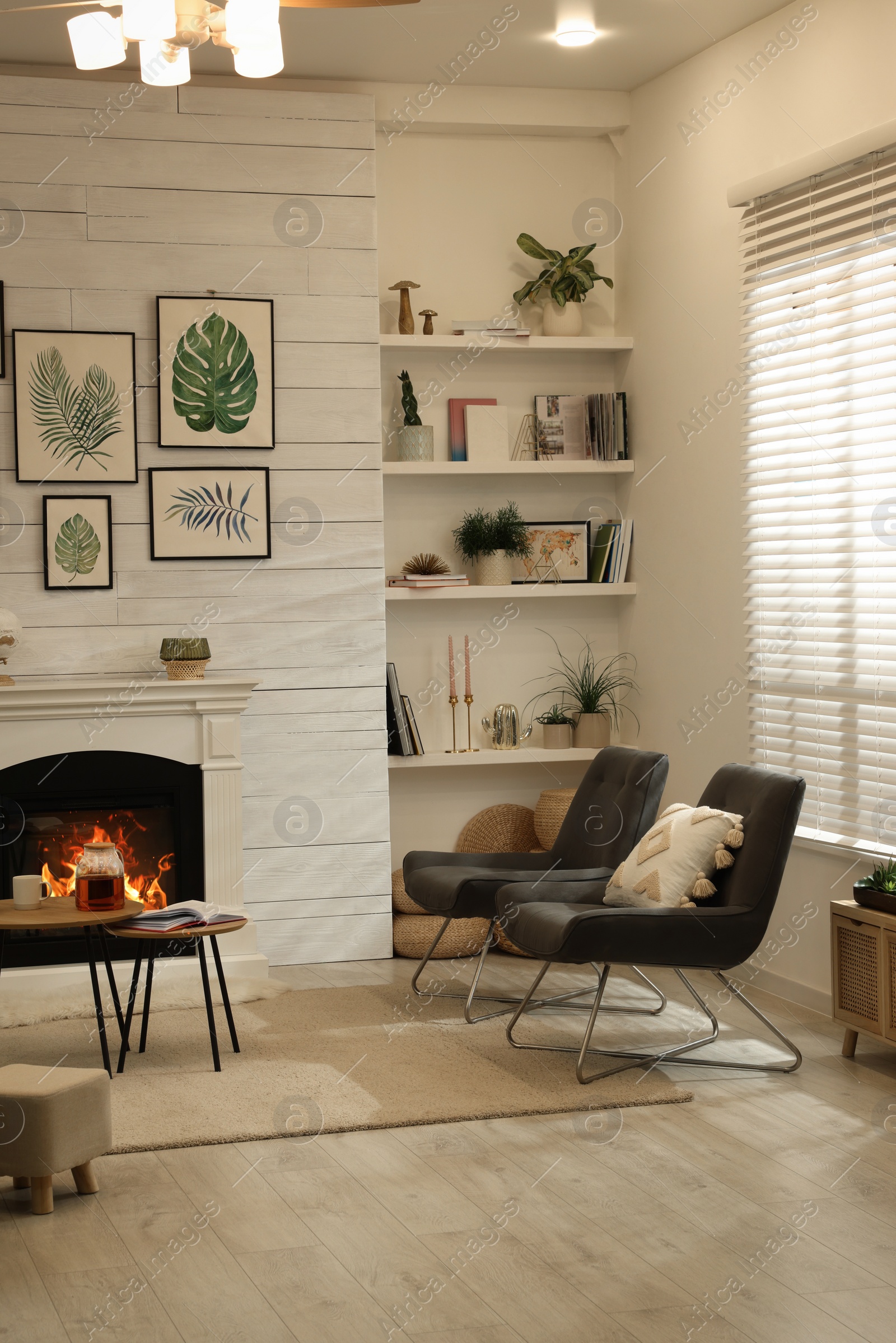 Photo of Stylish living room interior with comfortable chairs and decorative fireplace