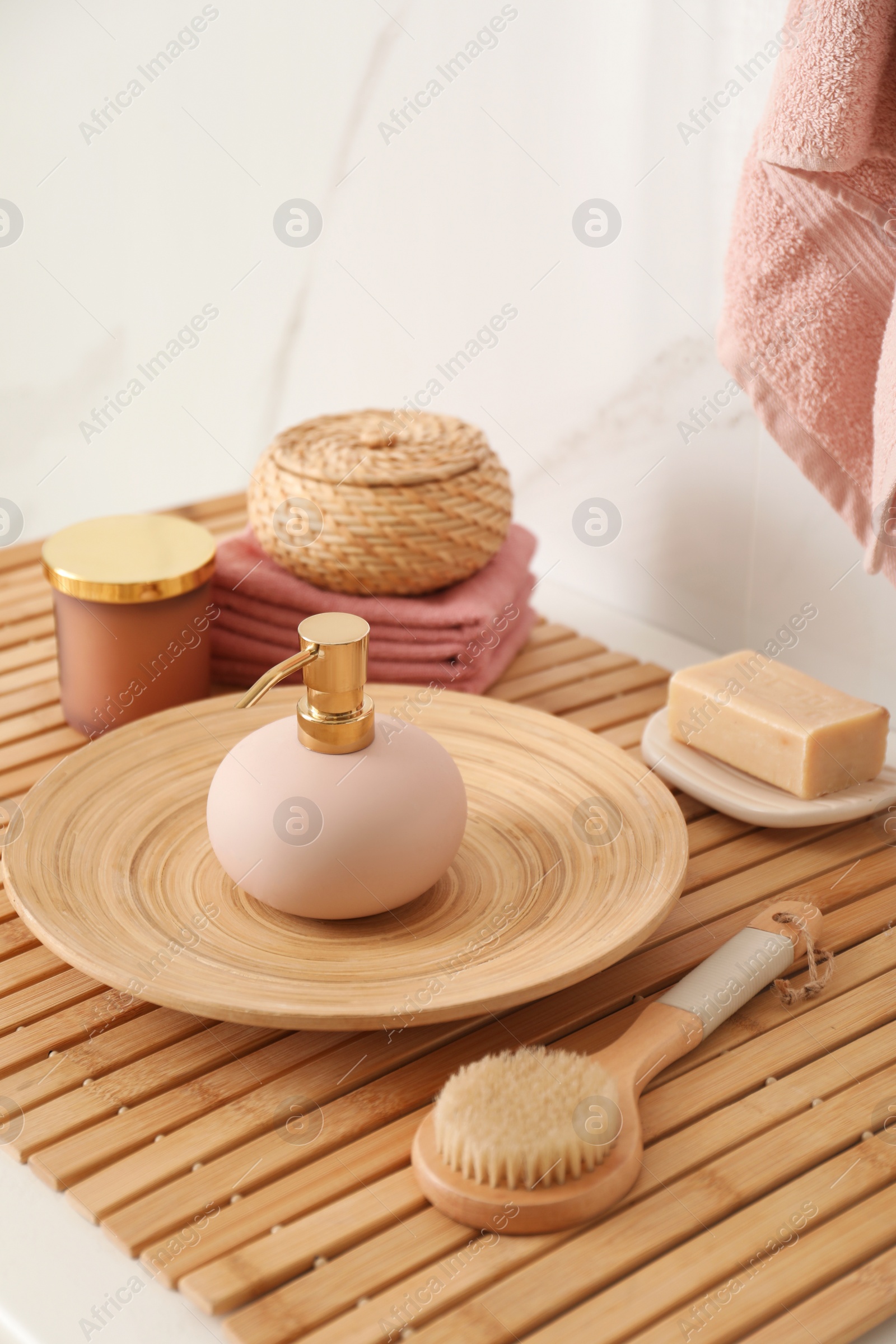 Photo of Different toiletries on wooden countertop in bathroom