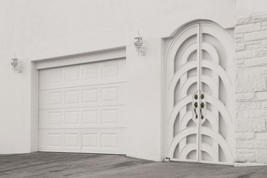 Photo of Entrance of house with beautiful arched door and gates