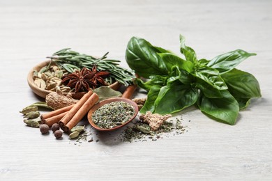 Photo of Different natural spices and herbs on light wooden table