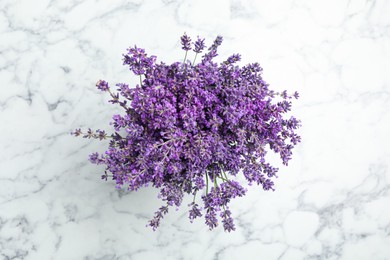 Beautiful lavender bouquet on white marble table, top view