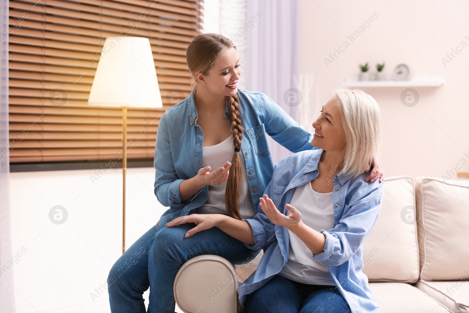 Photo of Mother and her adult daughter spending time together at home