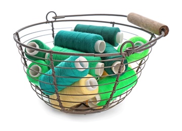 Photo of Basket with set of color sewing threads on white background