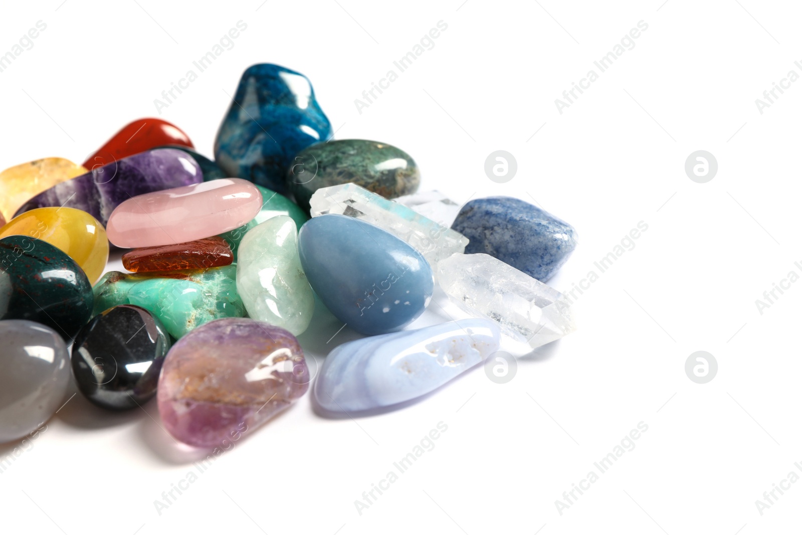 Photo of Pile of different beautiful gemstones on white background