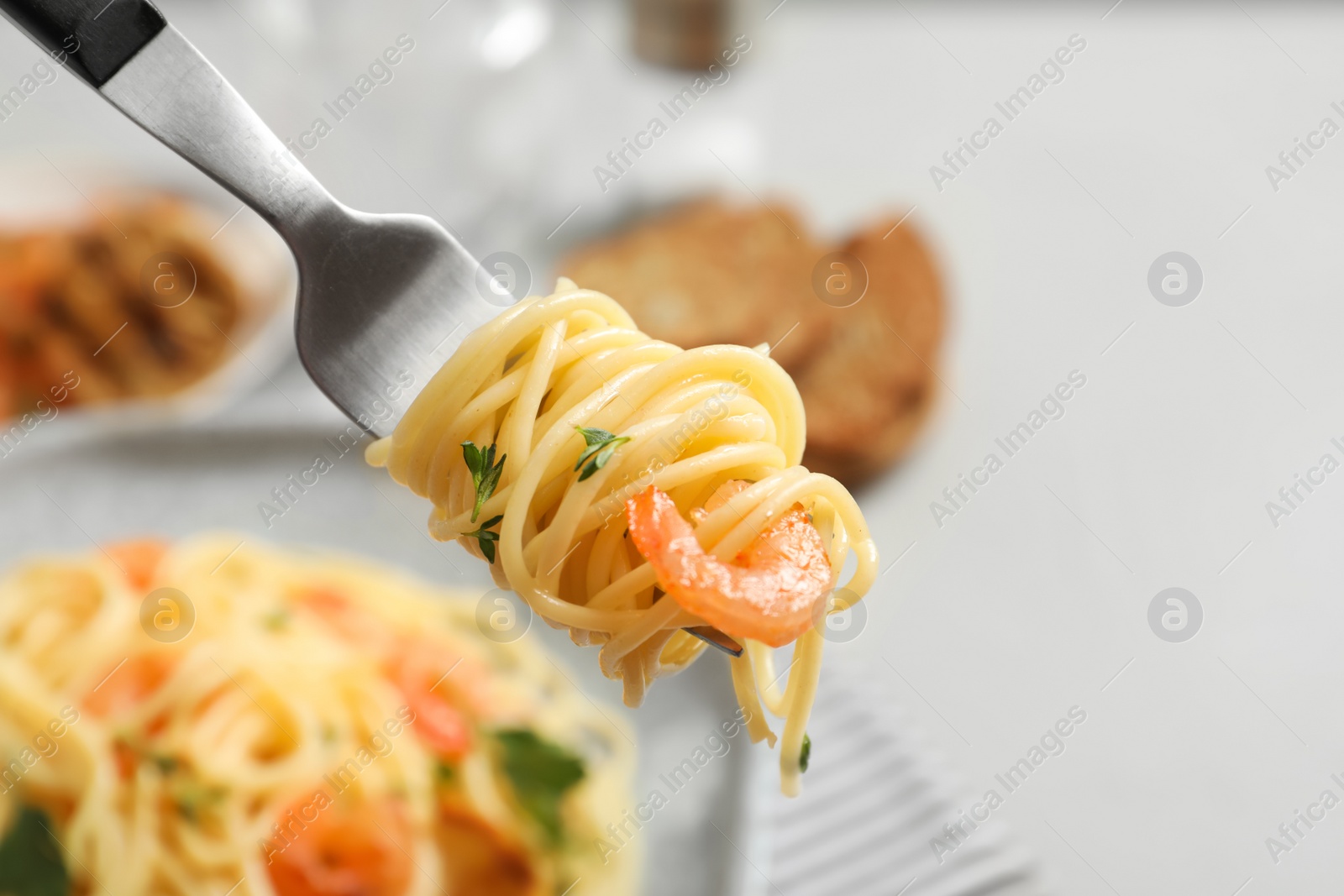 Photo of Eating of delicious pasta with shrimp, closeup
