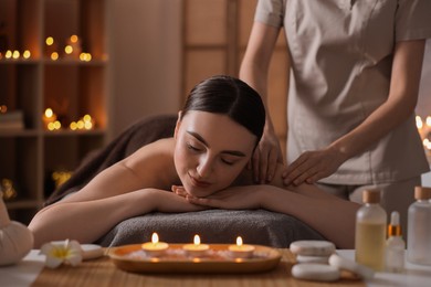 Photo of Spa therapy. Beautiful young woman lying on table during massage in salon