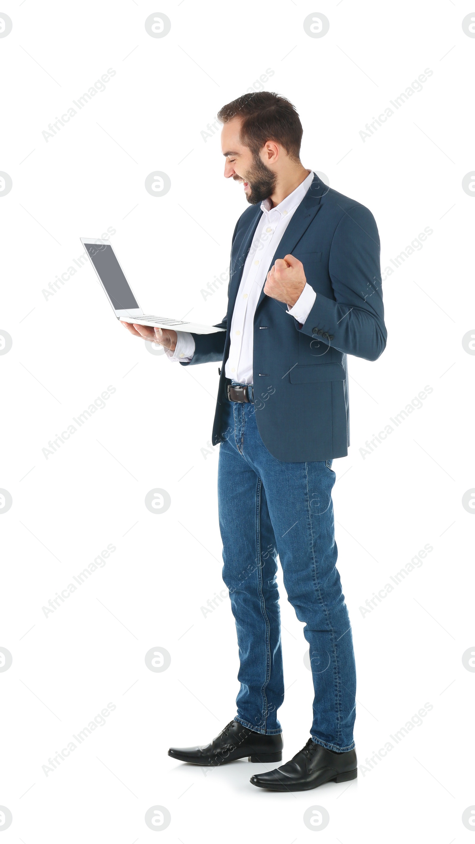 Photo of Emotional businessman in office wear with laptop celebrating victory on white background