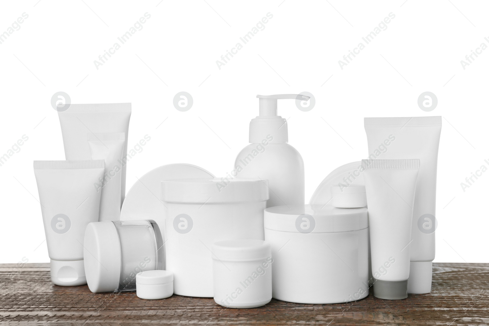 Photo of Set of different cosmetic products on wooden table against white background