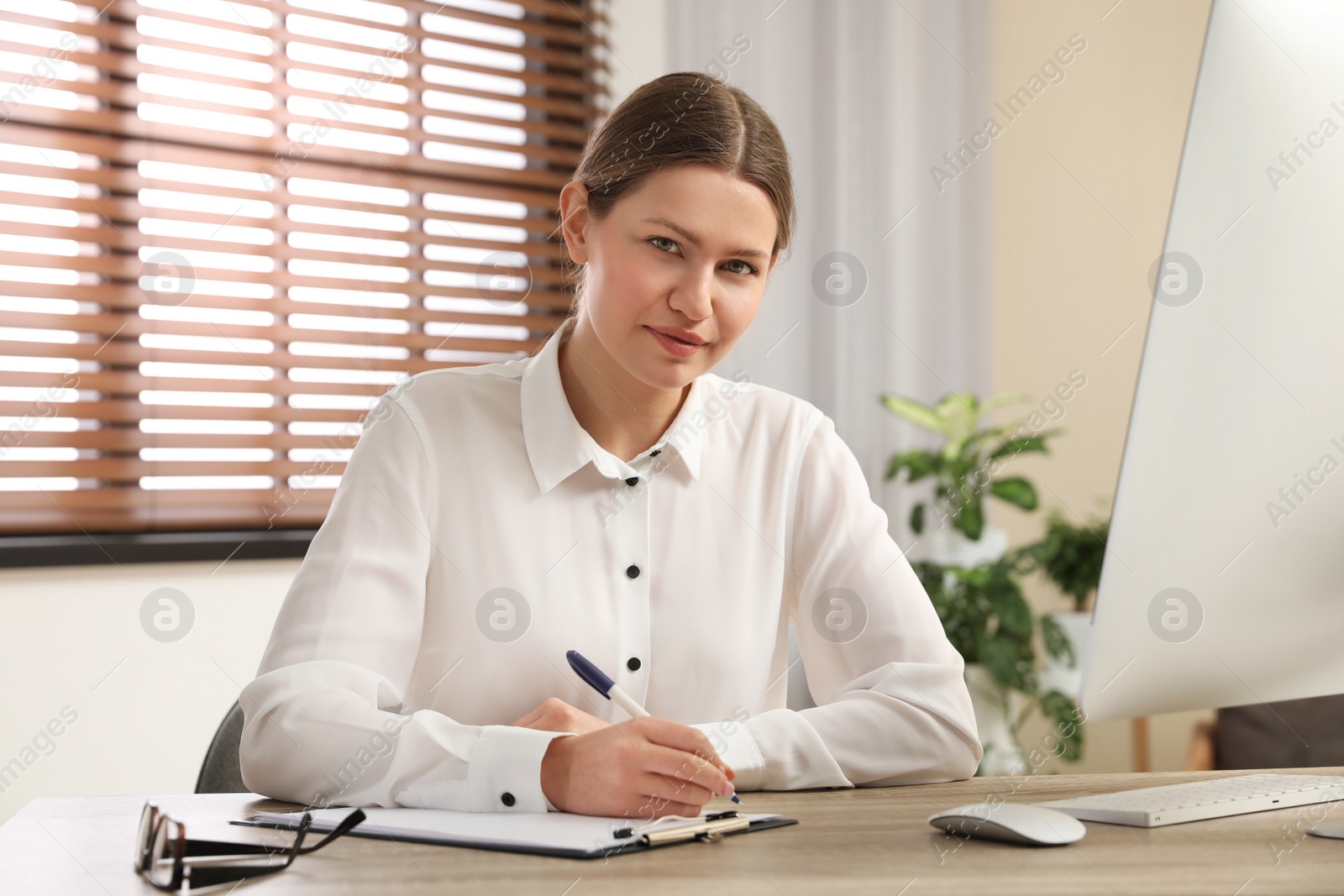 Photo of Professional psychotherapist at table in modern office