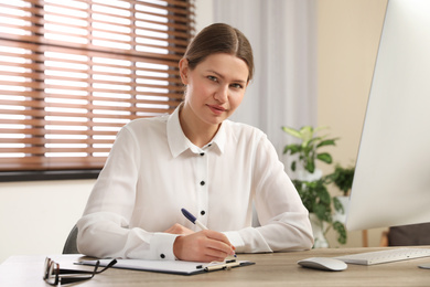 Professional psychotherapist at table in modern office