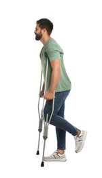Photo of Young man with axillary crutches on white background