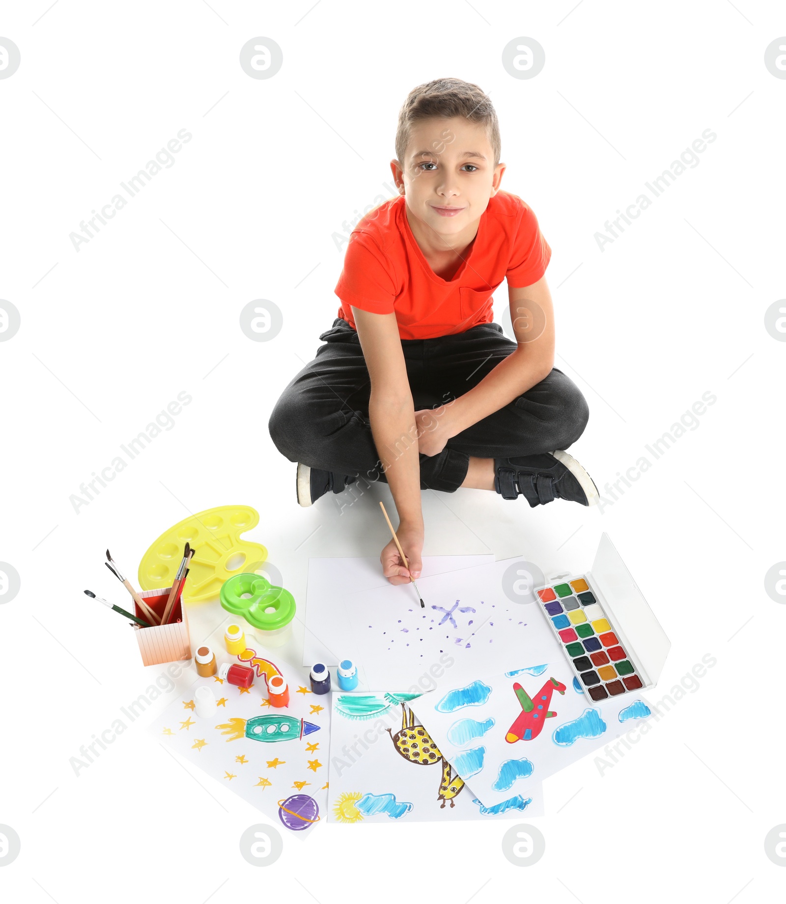Photo of Cute child painting picture on white background