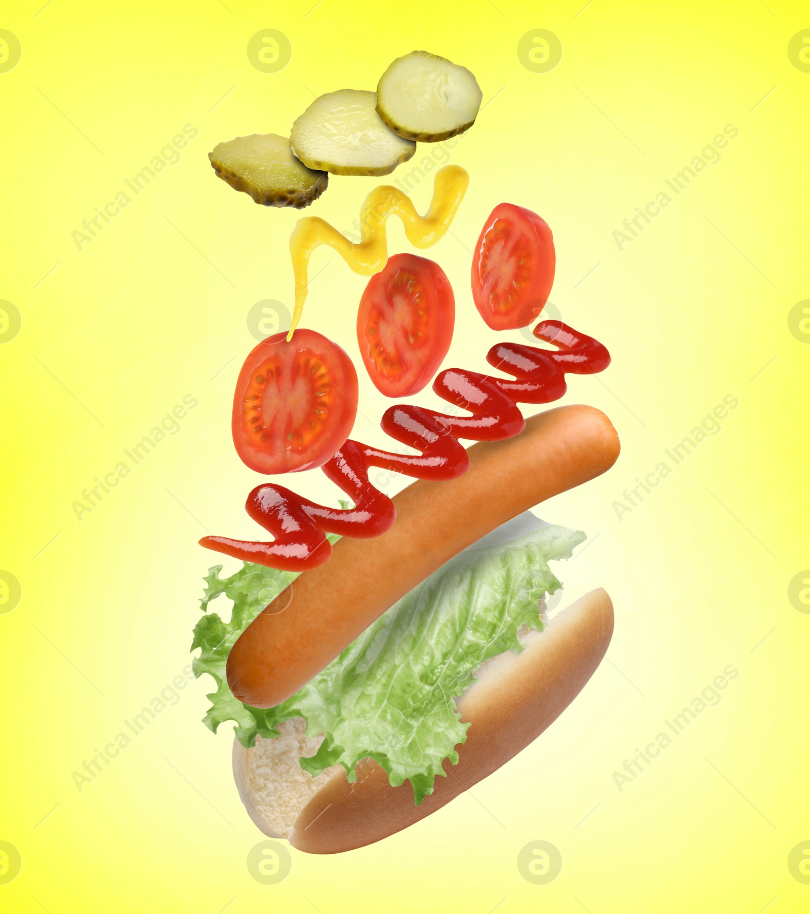 Image of Hot dog ingredients in air on yellow background