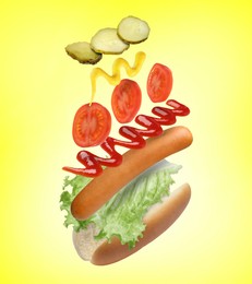 Image of Hot dog ingredients in air on yellow background