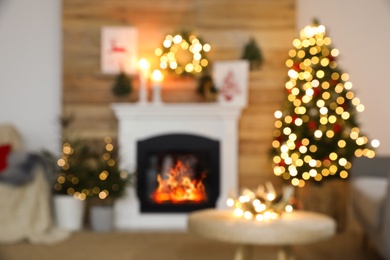 Photo of Blurred view of fireplace in living room decorated for Christmas