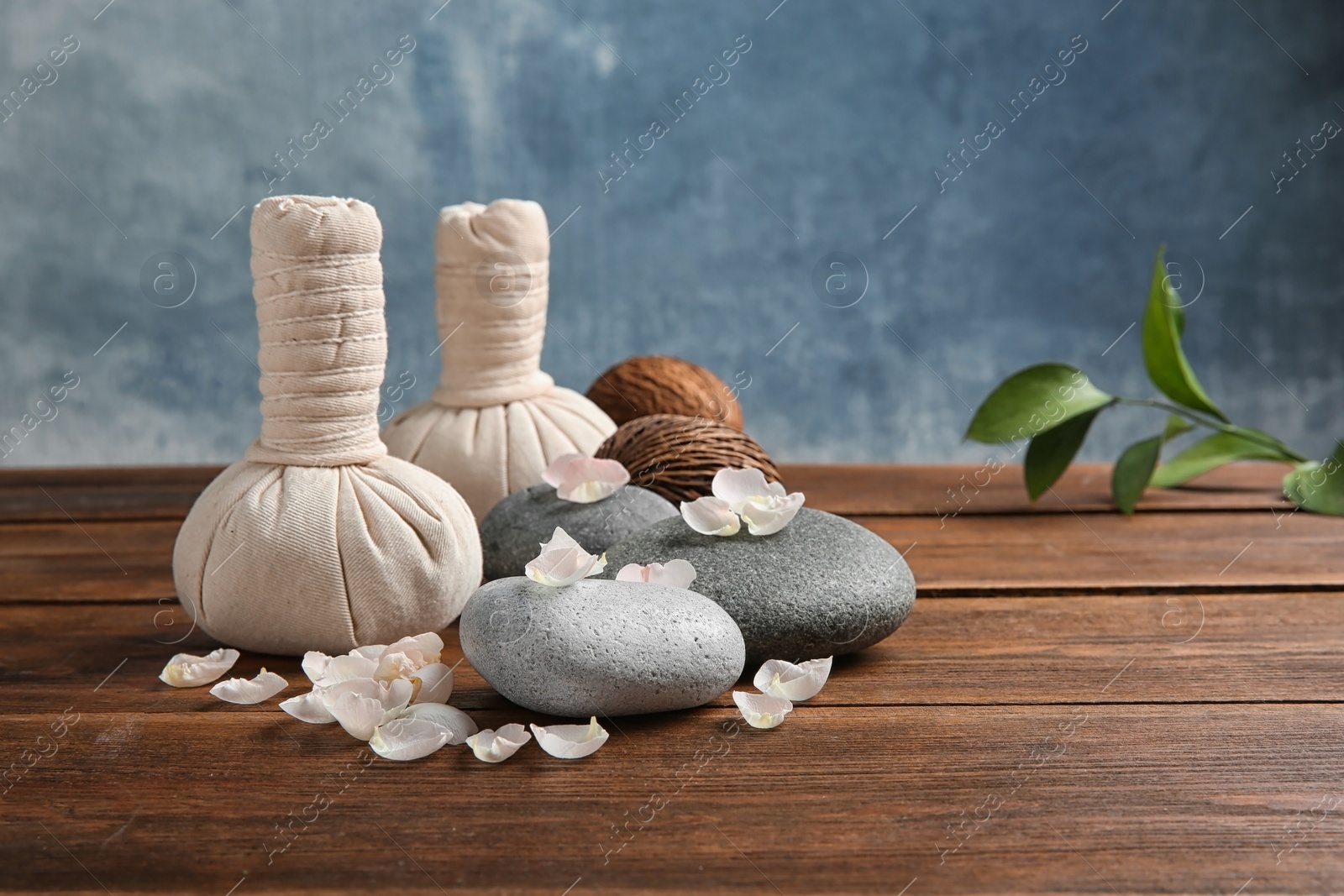 Photo of Beautiful composition with spa stones on wooden table. Space for text