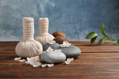 Beautiful composition with spa stones on wooden table. Space for text