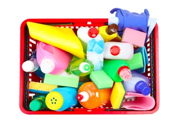 Photo of Shopping basket with different detergents and rag on white background, top view