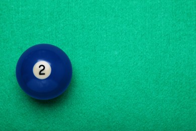 Billiard ball with number 2 on green table, top view. Space for text