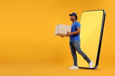 Courier with parcel walking out from huge smartphone on orange background. Delivery service. Space for text
