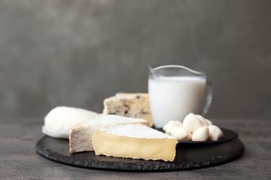Photo of Different dairy products on table against grey background