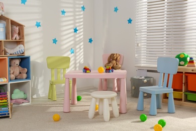 Photo of Cozy baby room interior with stylish furniture