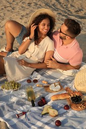 Photo of Lovely couple having picnic outdoors on sunny day