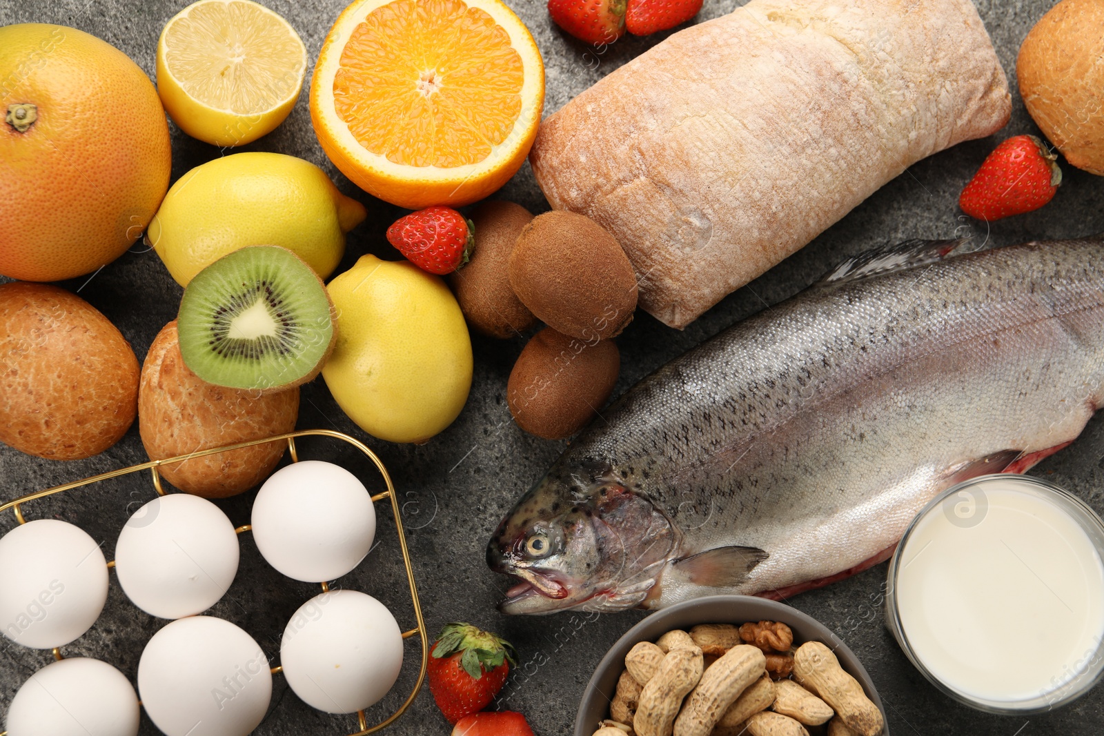 Photo of Allergenic food. Different fresh products on grey table, flat lay